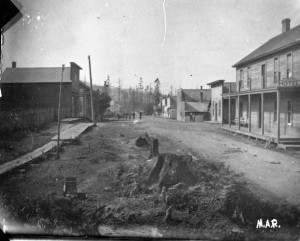 45188 -Langlois- ealy Langlois street scene with a hotel on the right and stumps in the road, DeOs coll. neg # 163